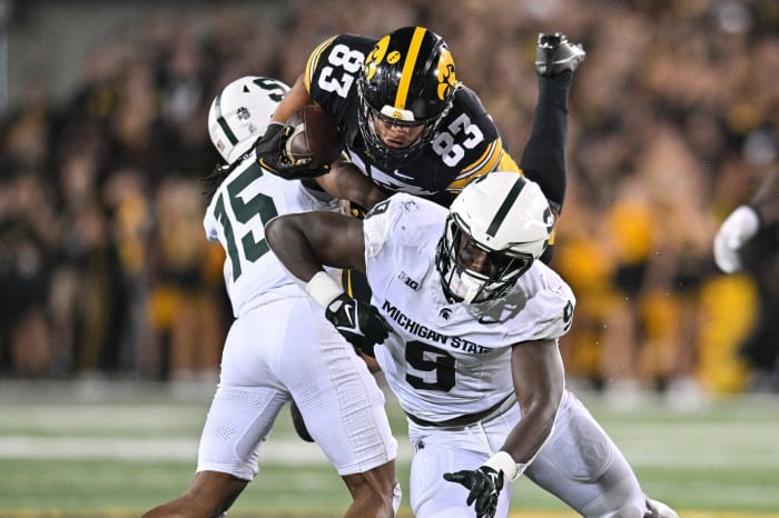 Sep 30, 2023; Iowa City, Iowa, USA; Michigan State Spartans defensive lineman Zion Young (9) and defensive back Angelo Grose (15) tackle Iowa Hawkeyes tight end Erick All (83) during the fourth quarter at Kinnick Stadium. Mandatory Credit: Jeffrey Becker-USA TODAY Sports